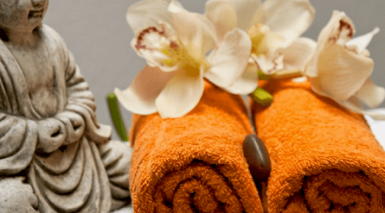 orange towels with buddha and flowers
