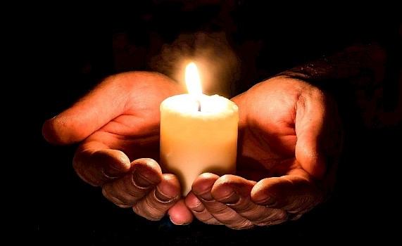hands holding a candle to help with anxiety and depression