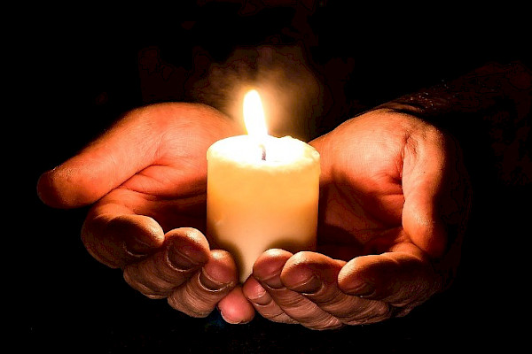 hands holding a candle to help with anxiety and depression