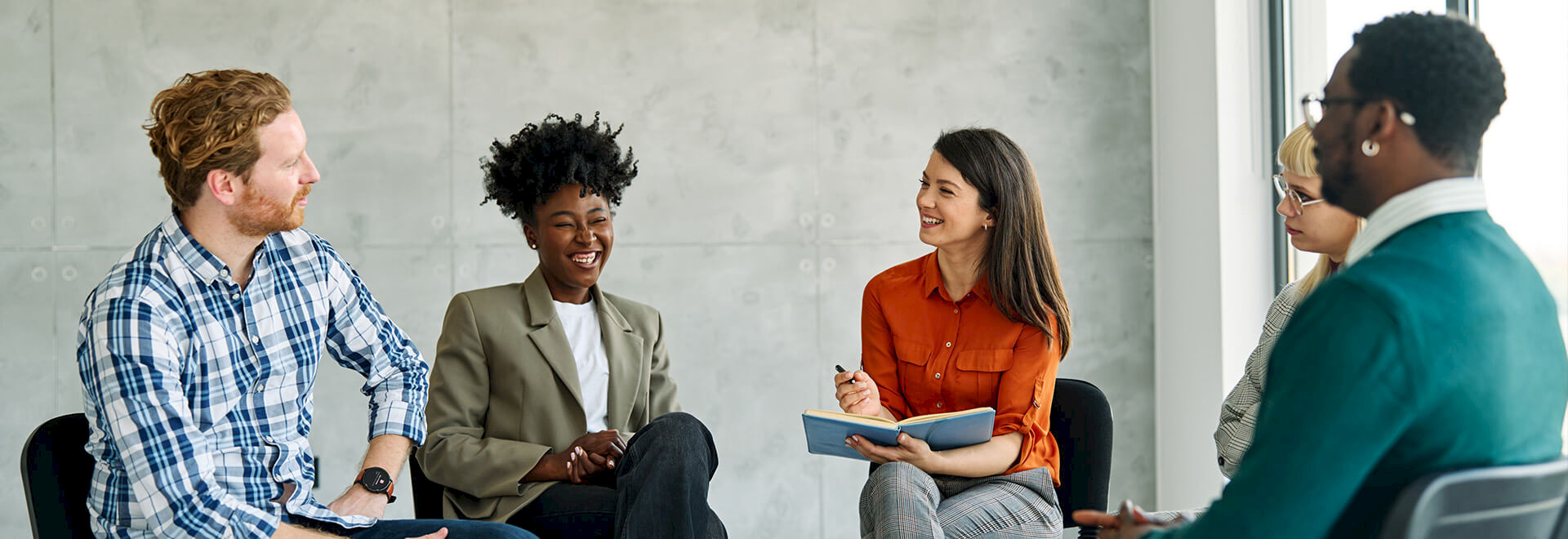Professional team members sitting together for a brainstorming session or group workshop.