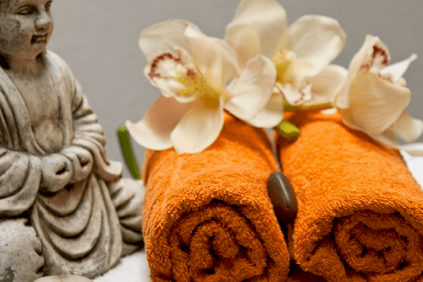 orange towels with buddha and flowers